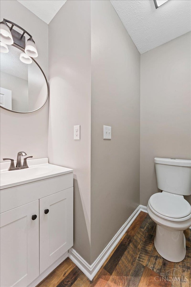 2535 Crane Schoolhouse Rd, Tate Twp, OH 45106 - half bath featuring vanity, a textured ceiling, and wood finished floors