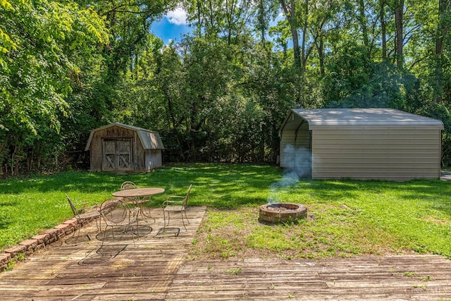 989 E Ogden Rd, Adams Twp, OH 45177 - view of grassy yard with a shed, an outdoor fire pit, and a deck