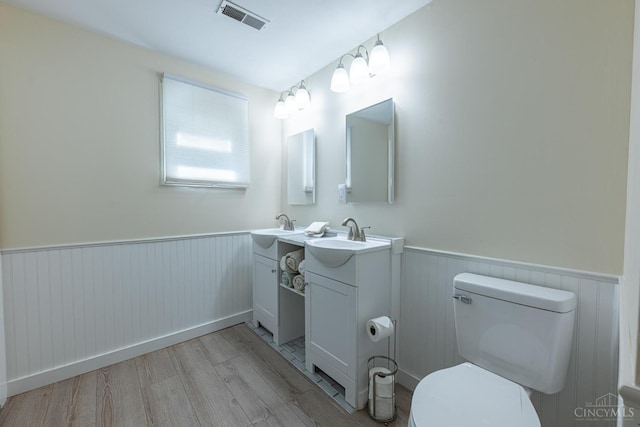 989 E Ogden Rd, Adams Twp, OH 45177 - bathroom featuring vanity, a wainscoted wall, and wood finished floors