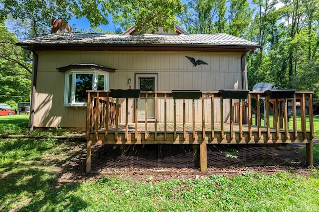989 E Ogden Rd, Adams Twp, OH 45177 - rear view of house with a chimney, a wooden deck, and a metal roof