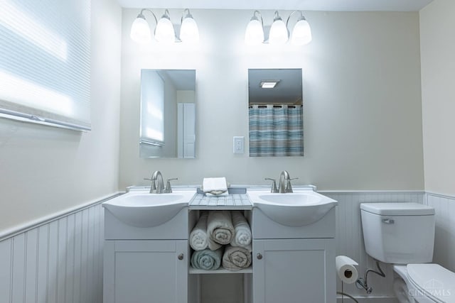 989 E Ogden Rd, Adams Twp, OH 45177 - full bath with a wainscoted wall and double vanity