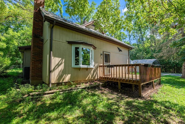 989 E Ogden Rd, Adams Twp, OH 45177 - rear view of house featuring a chimney, a wooden deck, and a lawn