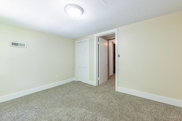 989 E Ogden Rd, Adams Twp, OH 45177 - unfurnished bedroom with carpet flooring, a closet, and a textured ceiling