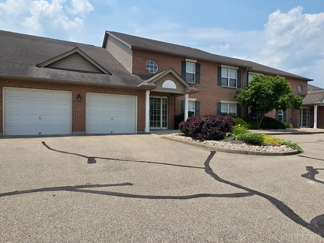 311 Miami Trce Unit 5, Harrison, OH 45030 - view of front of house featuring brick siding, a garage, and asphalt driveway