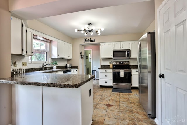 6330 Branch Hill Miamiville Rd, Miami Twp, OH 45140 - kitchen featuring appliances with stainless steel finishes, a peninsula, dark countertops, and white cabinetry