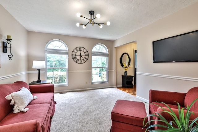 6330 Branch Hill Miamiville Rd, Miami Twp, OH 45140 - carpeted living room with a chandelier and baseboards
