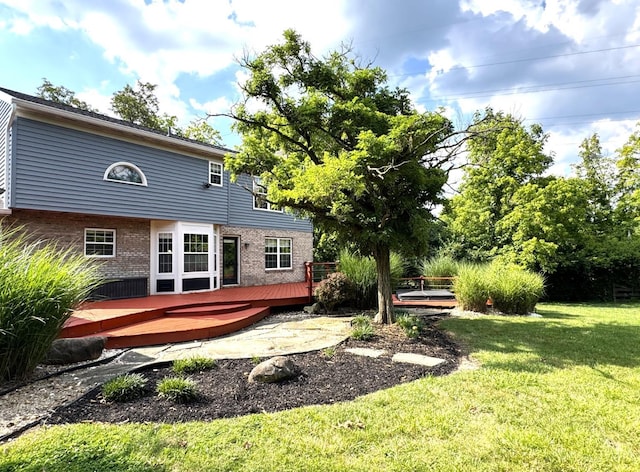 6330 Branch Hill Miamiville Rd, Miami Twp, OH 45140 - rear view of house featuring a wooden deck, brick siding, and a lawn