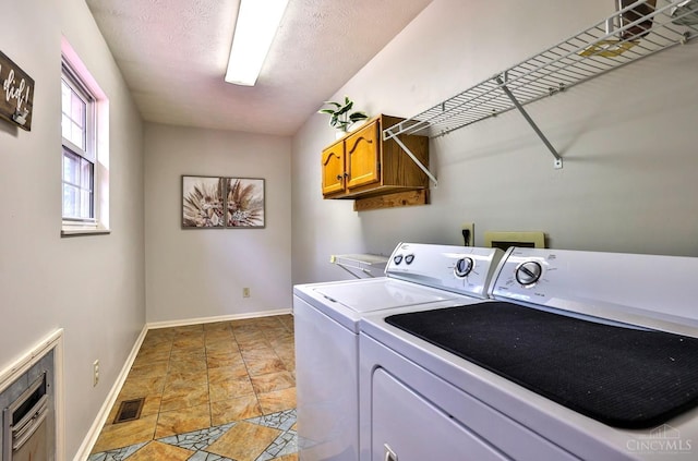 6330 Branch Hill Miamiville Rd, Miami Twp, OH 45140 - laundry area featuring washer and clothes dryer, stone finish floors, and cabinet space