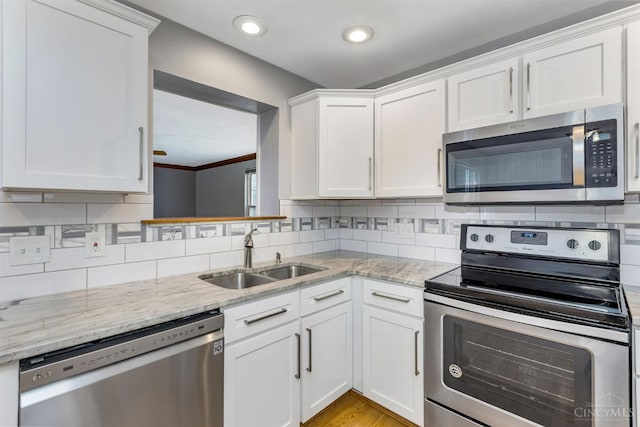 3324 Moonridge Dr, Green Twp, OH 45248 - kitchen featuring stainless steel appliances, white cabinets, backsplash, light stone countertops, and recessed lighting