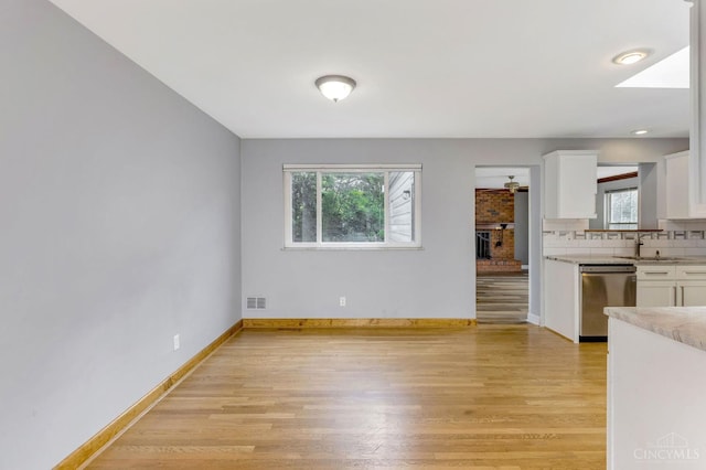 3324 Moonridge Dr, Green Twp, OH 45248 - kitchen with dishwasher, plenty of natural light, and white cabinets