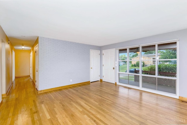 3324 Moonridge Dr, Green Twp, OH 45248 - empty room featuring light wood-type flooring and brick wall