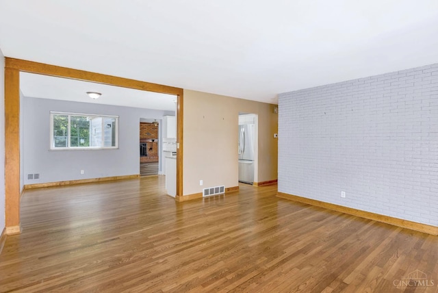 3324 Moonridge Dr, Green Twp, OH 45248 - empty room with light wood-style flooring and brick wall