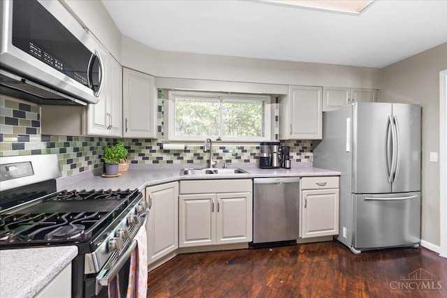 281 Compton Rd, Wyoming, OH 45215 - kitchen featuring appliances with stainless steel finishes, light countertops, dark wood-style flooring, and decorative backsplash