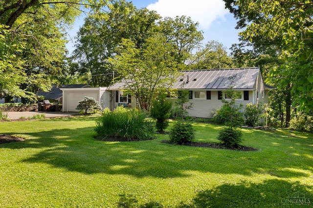 281 Compton Rd, Wyoming, OH 45215 - view of green lawn with a garage and concrete driveway