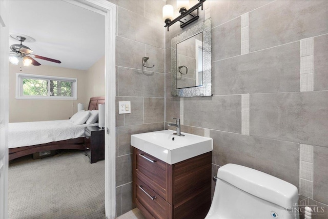 281 Compton Rd, Wyoming, OH 45215 - bathroom with vanity, tile walls, connected bathroom, and a ceiling fan