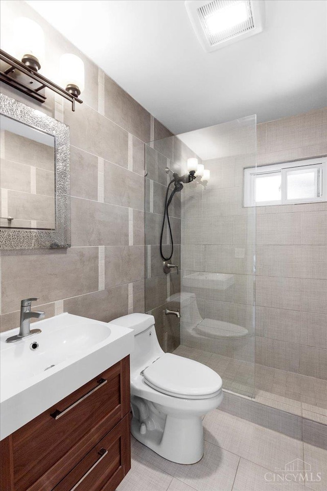 281 Compton Rd, Wyoming, OH 45215 - bathroom with tile walls, walk in shower, vanity, and tile patterned flooring