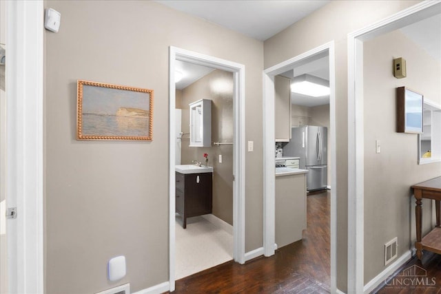 281 Compton Rd, Wyoming, OH 45215 - hallway featuring dark wood-style flooring and a sink