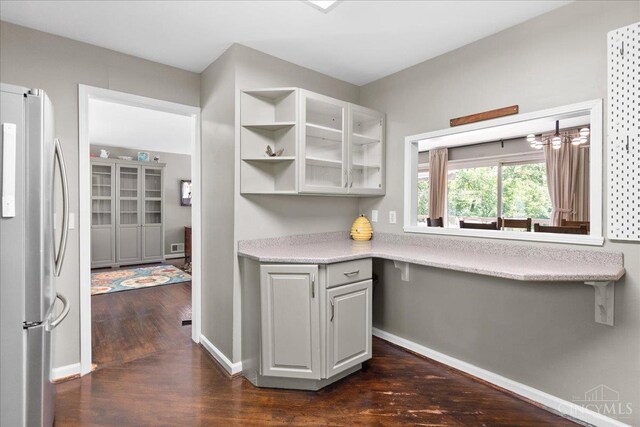 281 Compton Rd, Wyoming, OH 45215 - kitchen featuring freestanding refrigerator, dark wood-type flooring, light countertops, and glass insert cabinets