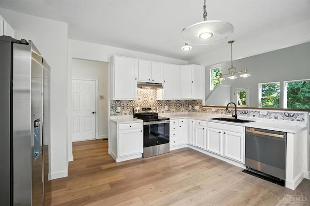 2380 Oaktree Pl, Cincinnati, OH 45238 - kitchen with stainless steel appliances, under cabinet range hood, tasteful backsplash, decorative light fixtures, and light countertops