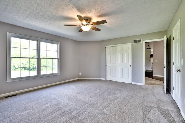 6154 Taylor Pike, Wayne Twp, OH 45107 - unfurnished bedroom featuring carpet flooring, a textured ceiling, a ceiling fan, and a closet