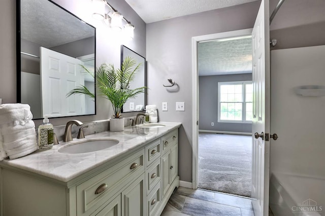 6154 Taylor Pike, Wayne Twp, OH 45107 - bathroom with double vanity and a textured ceiling