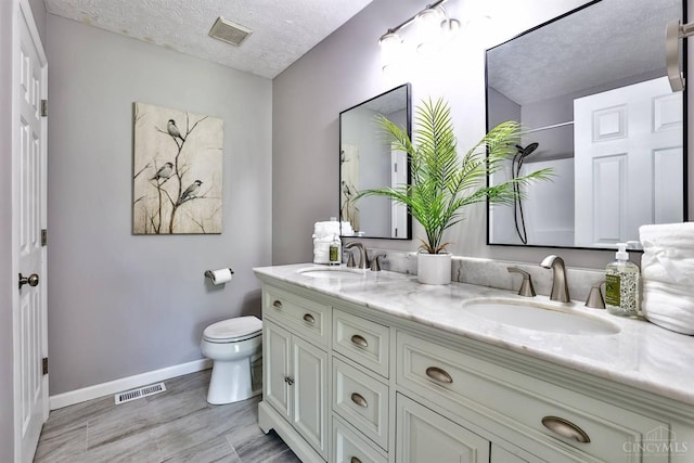 6154 Taylor Pike, Wayne Twp, OH 45107 - full bathroom featuring double vanity, a textured ceiling, wood finished floors, and a shower