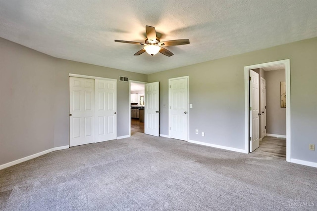 6154 Taylor Pike, Wayne Twp, OH 45107 - unfurnished bedroom featuring carpet, ensuite bath, a ceiling fan, and a textured ceiling