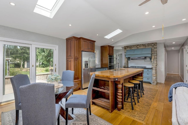 1050 Holz Ave, Anderson Twp, OH 45230 - dining space with a skylight, lofted ceiling, light wood finished floors, and recessed lighting