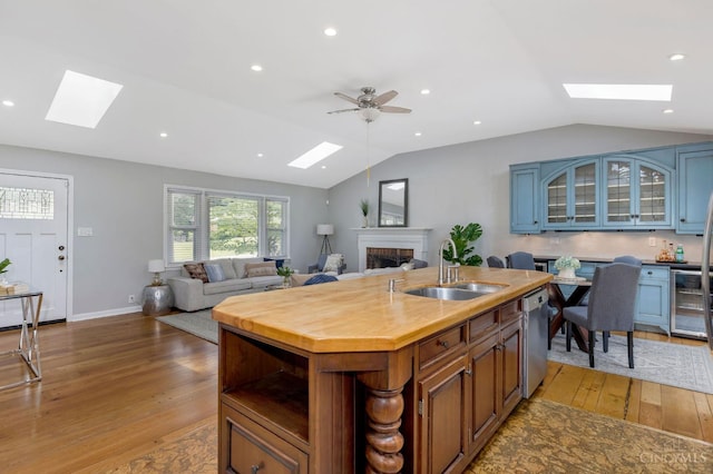 1050 Holz Ave, Anderson Twp, OH 45230 - kitchen with a skylight, vaulted ceiling, stainless steel dishwasher, light wood-style floors, and recessed lighting