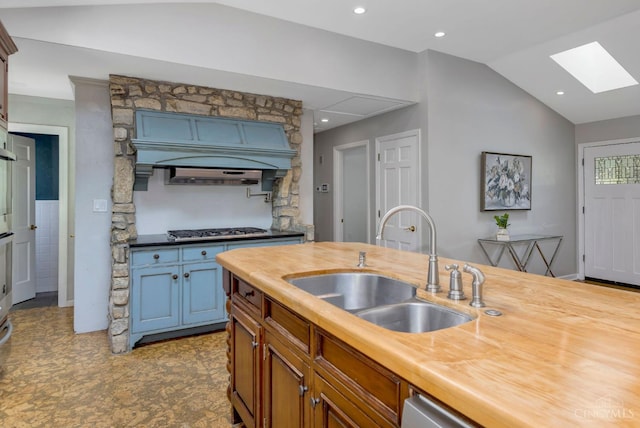 1050 Holz Ave, Anderson Twp, OH 45230 - kitchen with a skylight, stainless steel gas stovetop, vaulted ceiling, butcher block counters, and recessed lighting