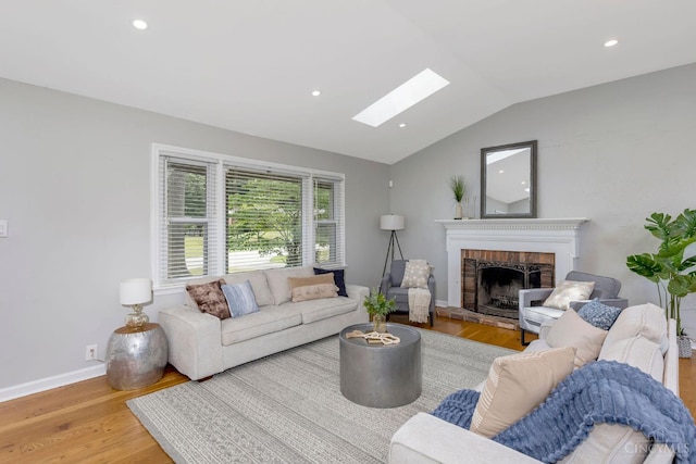 1050 Holz Ave, Anderson Twp, OH 45230 - living room with a skylight, wood finished floors, lofted ceiling, a fireplace, and recessed lighting