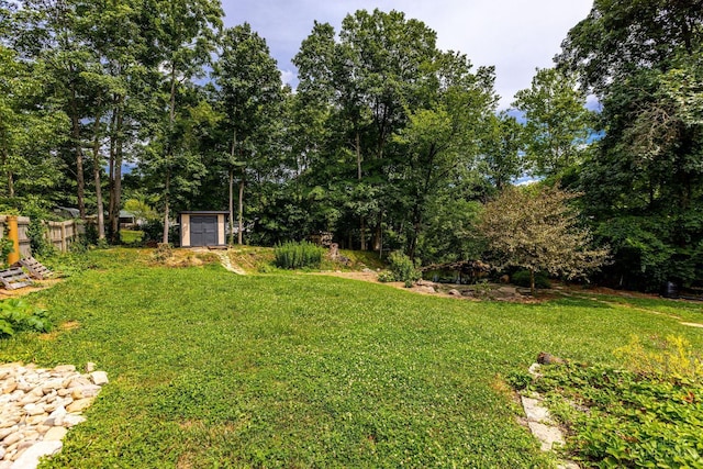 1050 Holz Ave, Anderson Twp, OH 45230 - view of green lawn with a storage unit and view of scattered trees