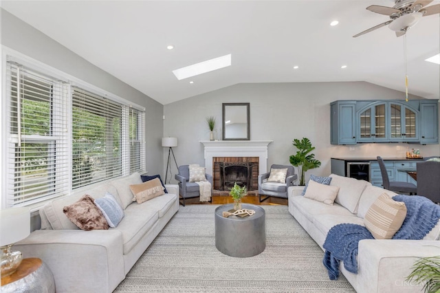 1050 Holz Ave, Anderson Twp, OH 45230 - living room with vaulted ceiling, a fireplace, a skylight, wine cooler, and a ceiling fan