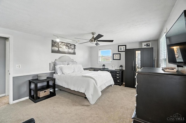 4961 Troubador Ct, Delhi Twp, OH 45238 - bedroom featuring light carpet, a textured ceiling, and ceiling fan