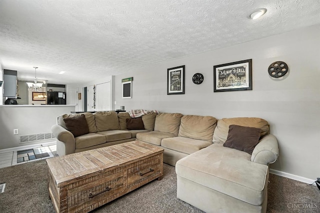 4961 Troubador Ct, Delhi Twp, OH 45238 - living room featuring a textured ceiling, carpet flooring, and a chandelier