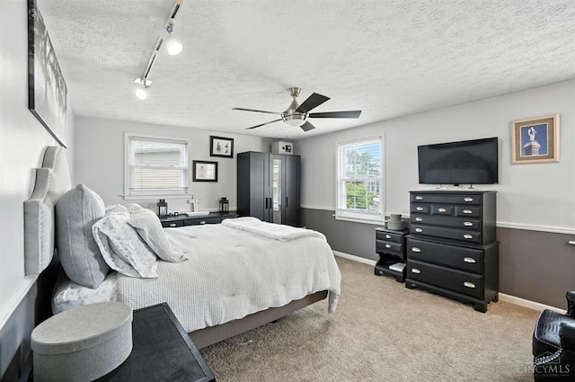 4961 Troubador Ct, Delhi Twp, OH 45238 - bedroom with track lighting, carpet flooring, a ceiling fan, and a textured ceiling