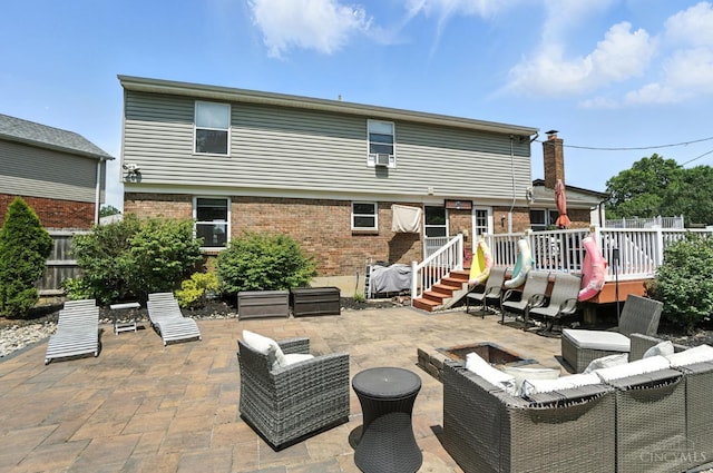4961 Troubador Ct, Delhi Twp, OH 45238 - back of house with a deck, a patio, an outdoor living space with a fire pit, and brick siding
