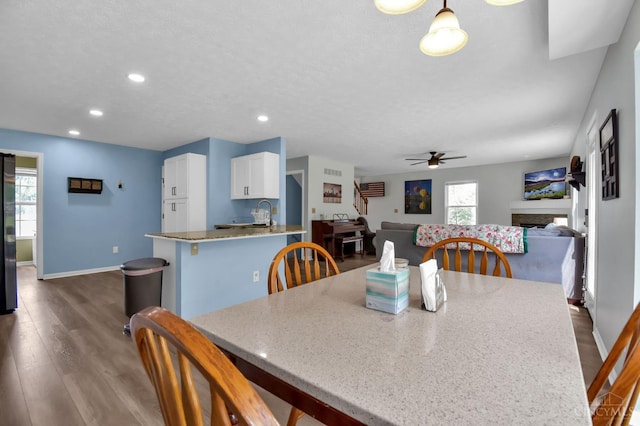 4411 Todd Rose Ct, Union Twp, OH 45244 - dining area with ceiling fan, dark wood-style flooring, recessed lighting, a fireplace, and a textured ceiling