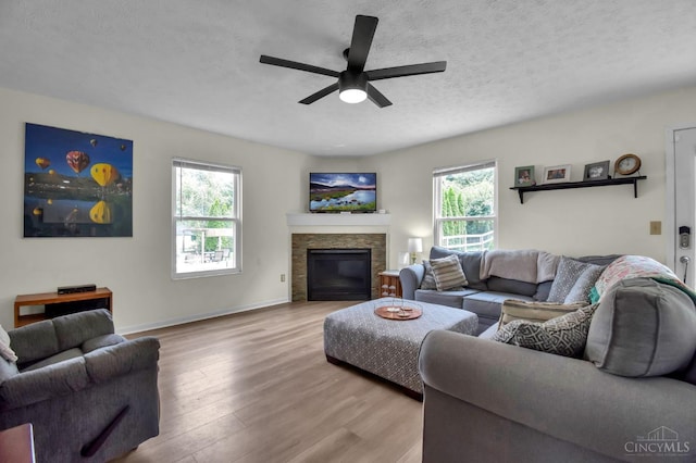 4411 Todd Rose Ct, Union Twp, OH 45244 - living room with ceiling fan, wood finished floors, a fireplace, and a textured ceiling