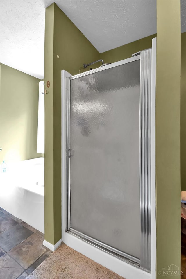 4411 Todd Rose Ct, Union Twp, OH 45244 - bathroom featuring a shower stall, a textured ceiling, stone finish flooring, and a bathtub