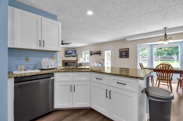 4411 Todd Rose Ct, Union Twp, OH 45244 - kitchen featuring dishwasher, a textured ceiling, a peninsula, a ceiling fan, and dark wood-style flooring