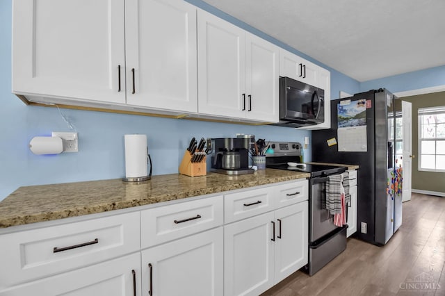 4411 Todd Rose Ct, Union Twp, OH 45244 - kitchen featuring stainless steel appliances, white cabinetry, light wood-style flooring, and light stone countertops