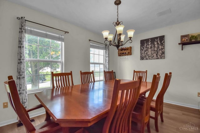 4411 Todd Rose Ct, Union Twp, OH 45244 - dining area featuring a chandelier, plenty of natural light, and wood finished floors