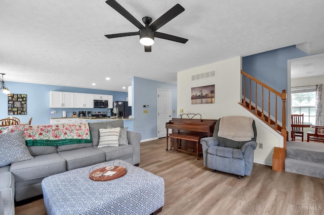 4411 Todd Rose Ct, Union Twp, OH 45244 - living area featuring light wood-style floors, a ceiling fan, a textured ceiling, stairway, and recessed lighting