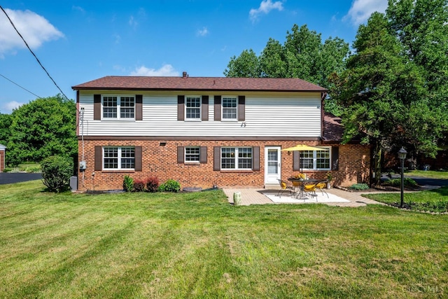 2724 Bentley Ct, Anderson Twp, OH 45244 - rear view of property featuring brick siding, a patio, and a yard