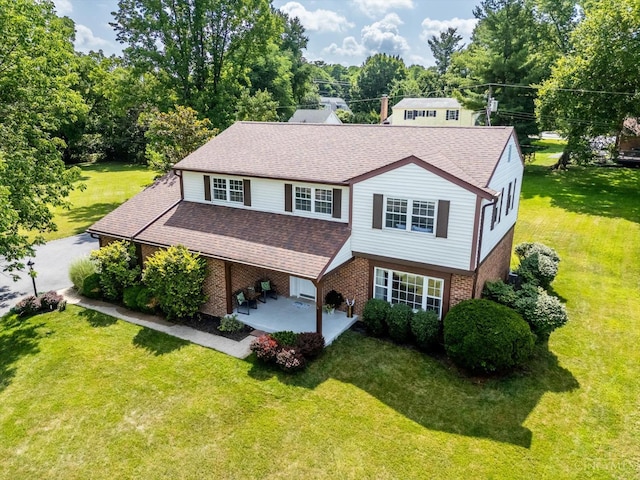 2724 Bentley Ct, Anderson Twp, OH 45244 - view of front of house with brick siding, roof with shingles, a patio area, and a front lawn