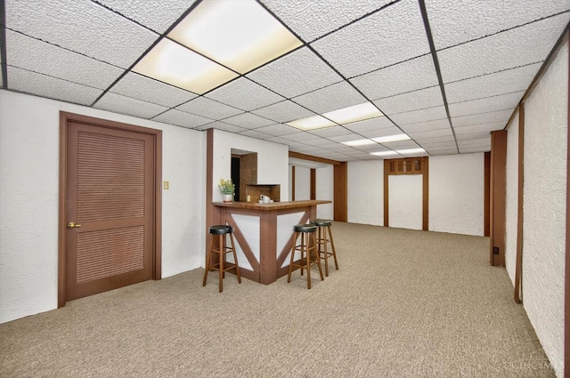 2724 Bentley Ct, Anderson Twp, OH 45244 - basement featuring a bar, carpet, a paneled ceiling, and a textured wall