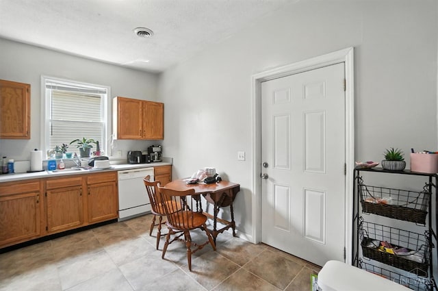 3254 Berwyn Pl, Cincinnati, OH 45209 - kitchen featuring dishwasher, light countertops, brown cabinets, and light tile patterned floors