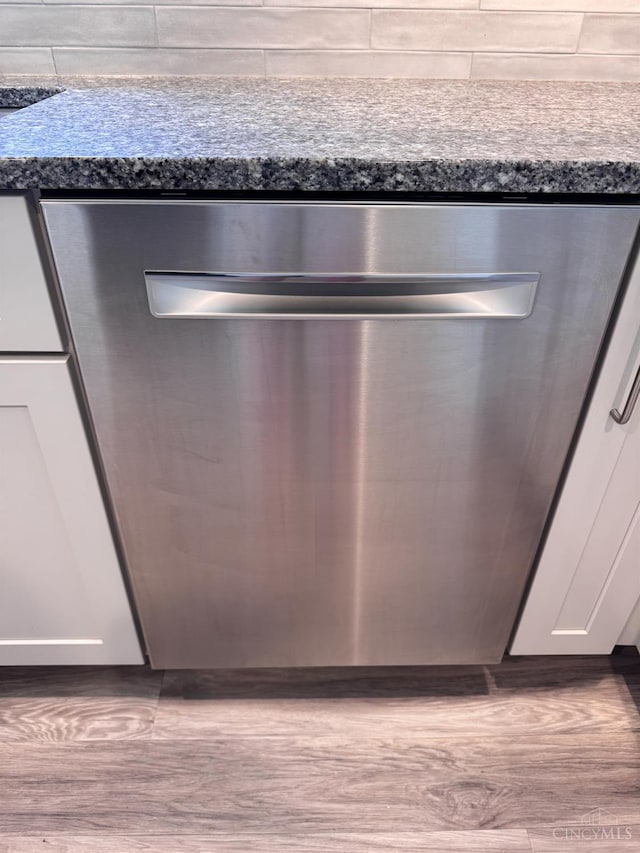 7102 Lookout Ct, Liberty Twp, OH 45011 - kitchen view of stainless steel dishwasher, dark countertops, and white cabinetry