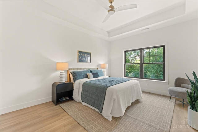 963 Windsor St, Cincinnati, OH 45206 - bedroom with light wood finished floors, a raised ceiling, and a ceiling fan